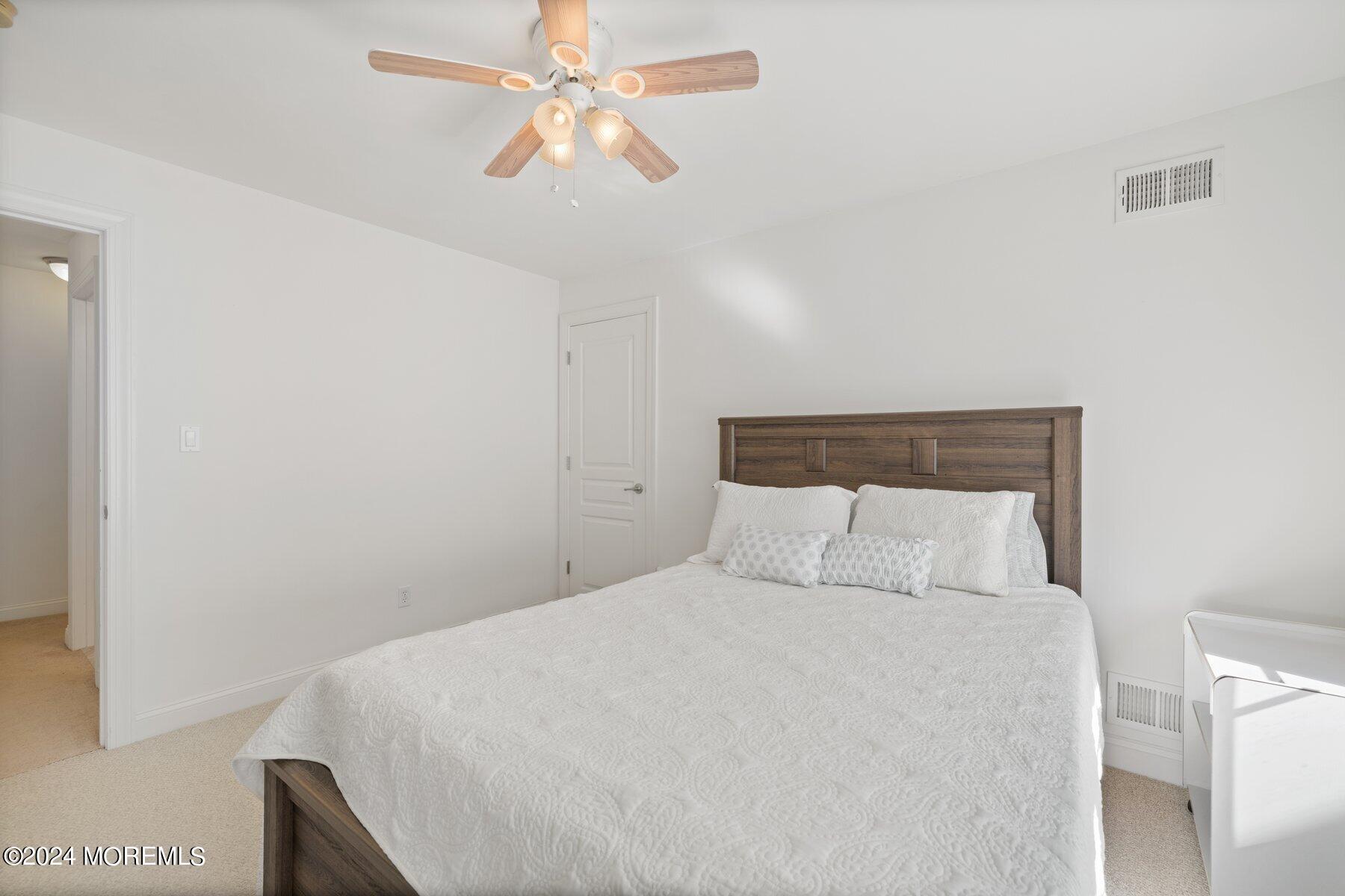 20 Silver Maple Lane Howell, NJ 07731 - Photo 28 of 35 a bedroom with a large bed and a chandelier
