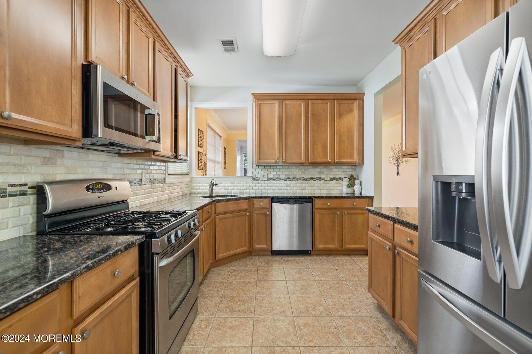 20 Silver Maple Lane Howell, NJ 07731 - Photo 5 of 35 a kitchen with stainless steel appliances granite countertop a stove a sink and a refrigerator