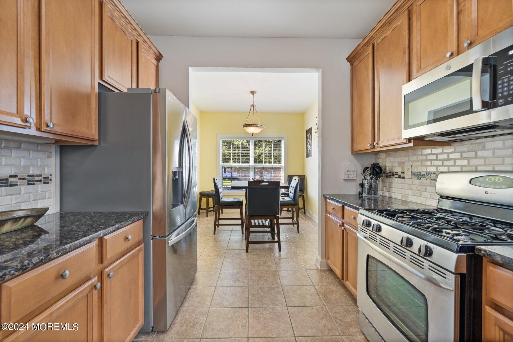 20 Silver Maple Lane Howell, NJ 07731 - Photo 7 of 35 a kitchen with stainless steel appliances granite countertop a stove a sink dishwasher and a refrigerator