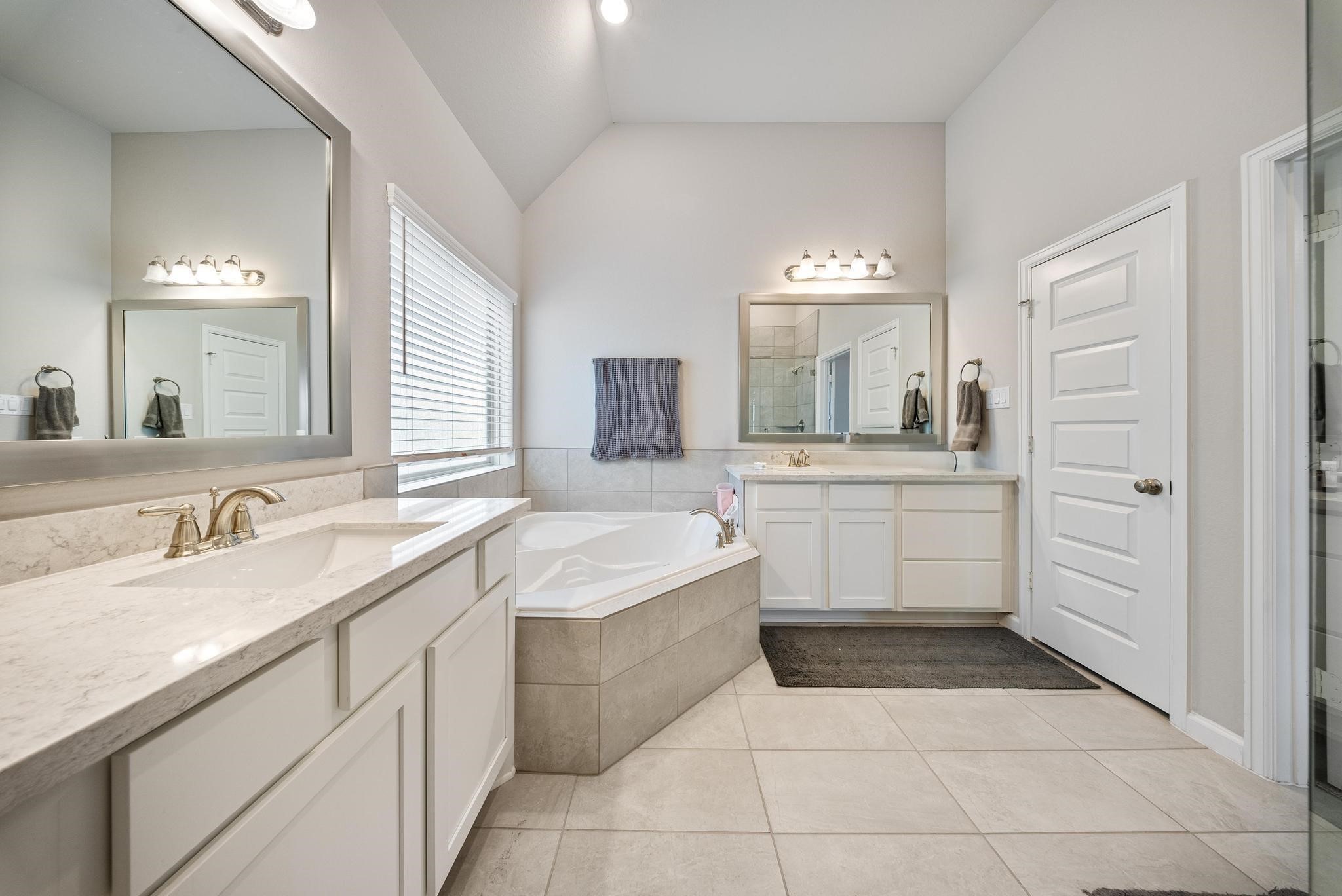 10605 Centre Green Way Houston, TX 77043 - Photo 16 of 22 a spacious bathroom with a granite countertop sink mirror and