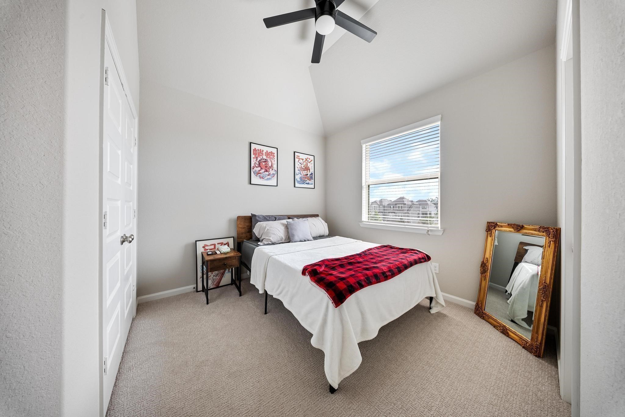 10605 Centre Green Way Houston, TX 77043 - Photo 18 of 22 a bedroom with a bed and a window
