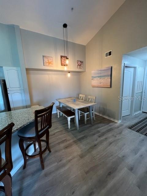 4170 Central Sarasota Parkway, Unit 428 Sarasota, FL 34238 - Photo 11 of 35 a living room with furniture and a wooden floor