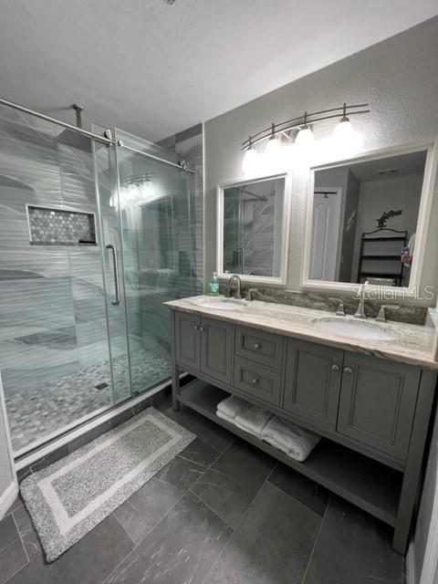 4170 Central Sarasota Parkway, Unit 428 Sarasota, FL 34238 - Photo 13 of 35 a bathroom with a double vanity sink mirror and shower