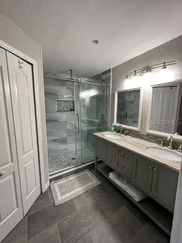 a bathroom with a double vanity sink and mirror