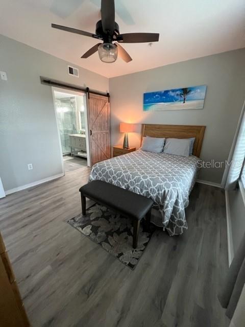 4170 Central Sarasota Parkway, Unit 428 Sarasota, FL 34238 - Photo 18 of 35 a bedroom with a bed a table and painting on the wall