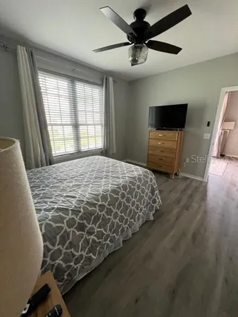 a bedroom with a bed and a mirror on the dresser