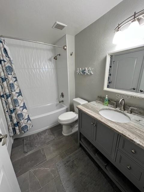 4170 Central Sarasota Parkway, Unit 428 Sarasota, FL 34238 - Photo 23 of 35 a spacious bathroom with a granite countertop sink a toilet a mirror and shower
