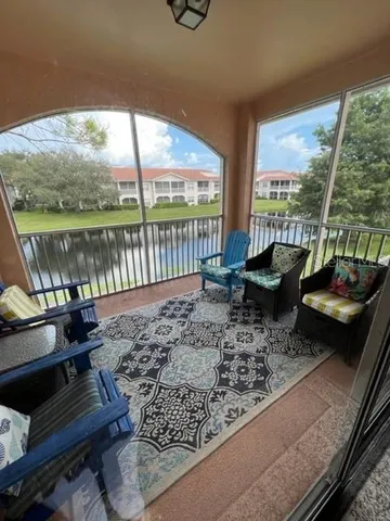 a living room with furniture and a floor to ceiling window