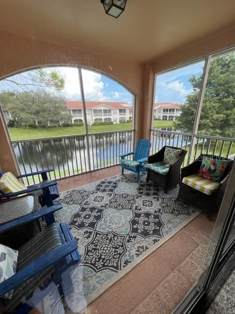4170 Central Sarasota Parkway, Unit 428 Sarasota, FL 34238 - Photo 25 of 35 a living room with large trees and furniture
