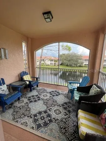 a living room with lots of furniture and kitchen view