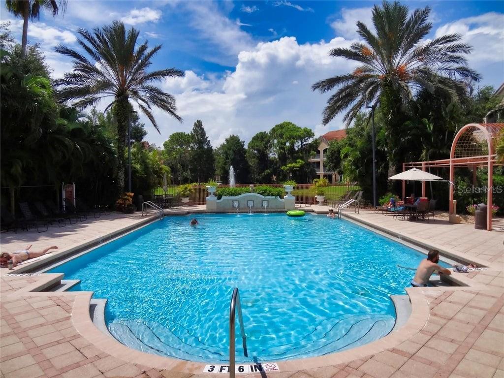 4170 Central Sarasota Parkway, Unit 428 Sarasota, FL 34238 - Photo 31 of 35 a view of a swimming pool with a sitting space