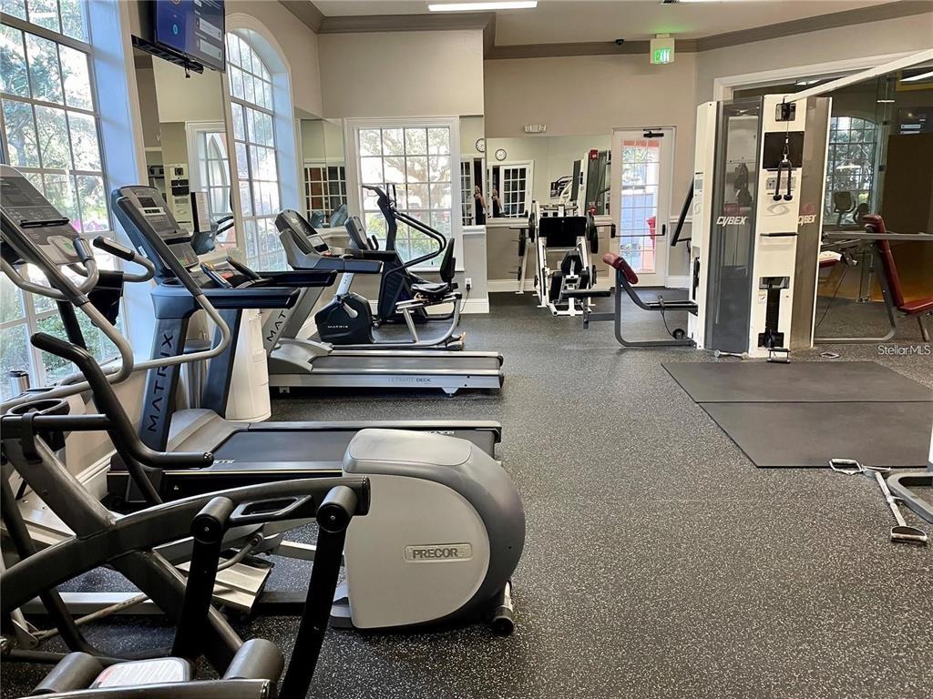 4170 Central Sarasota Parkway, Unit 428 Sarasota, FL 34238 - Photo 33 of 35 a room with gym equipment and large mirror