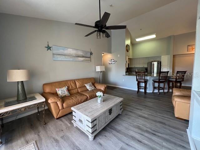 4170 Central Sarasota Parkway, Unit 428 Sarasota, FL 34238 - Photo 5 of 35 a living room with furniture and wooden floor