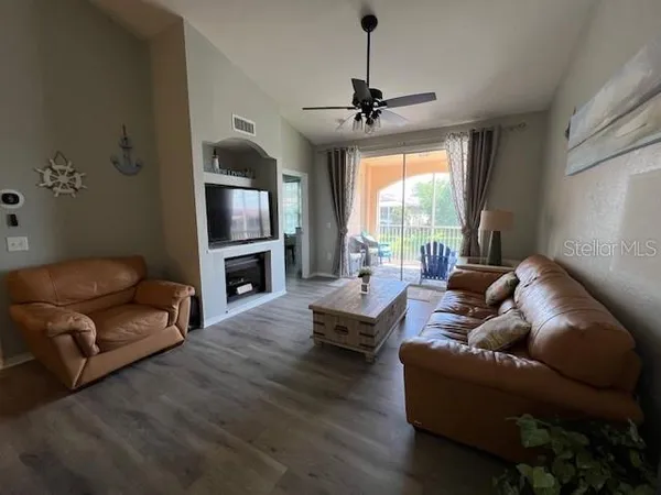 a living room with furniture and a chandelier