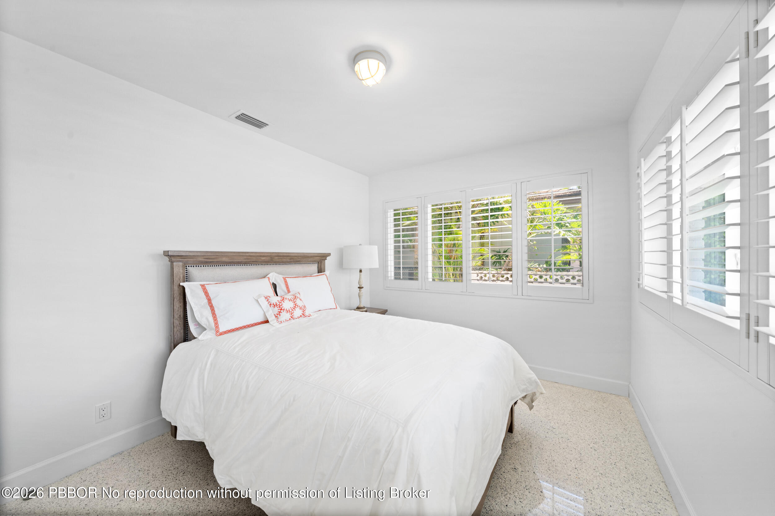 2259 Ibis Isle Road East, Unit E Palm Beach, FL 33480 - Photo 12 of 28 a large bed sitting in a bedroom next to a window