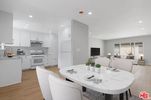 a view of kitchen with sink and refrigerator
