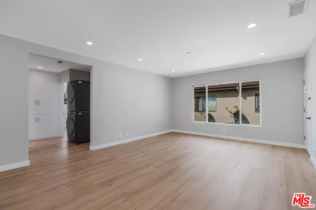 a view of wooden floor and windows in a room