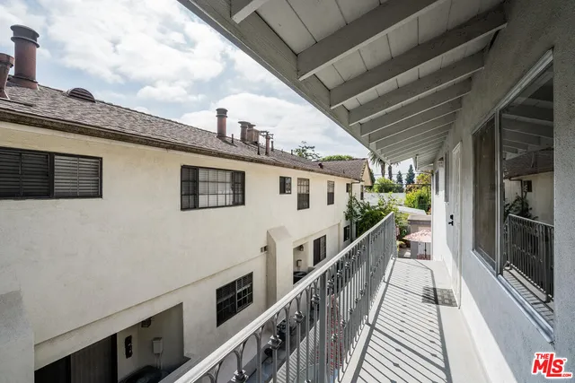 a view of a balcony with wooden floor and staircase