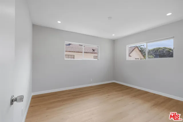 a view of a room with wooden floor and window