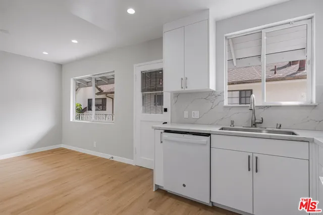 a kitchen with a sink cabinets and window