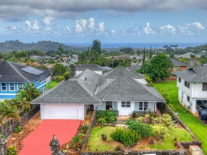 an aerial view of house with yard and green space