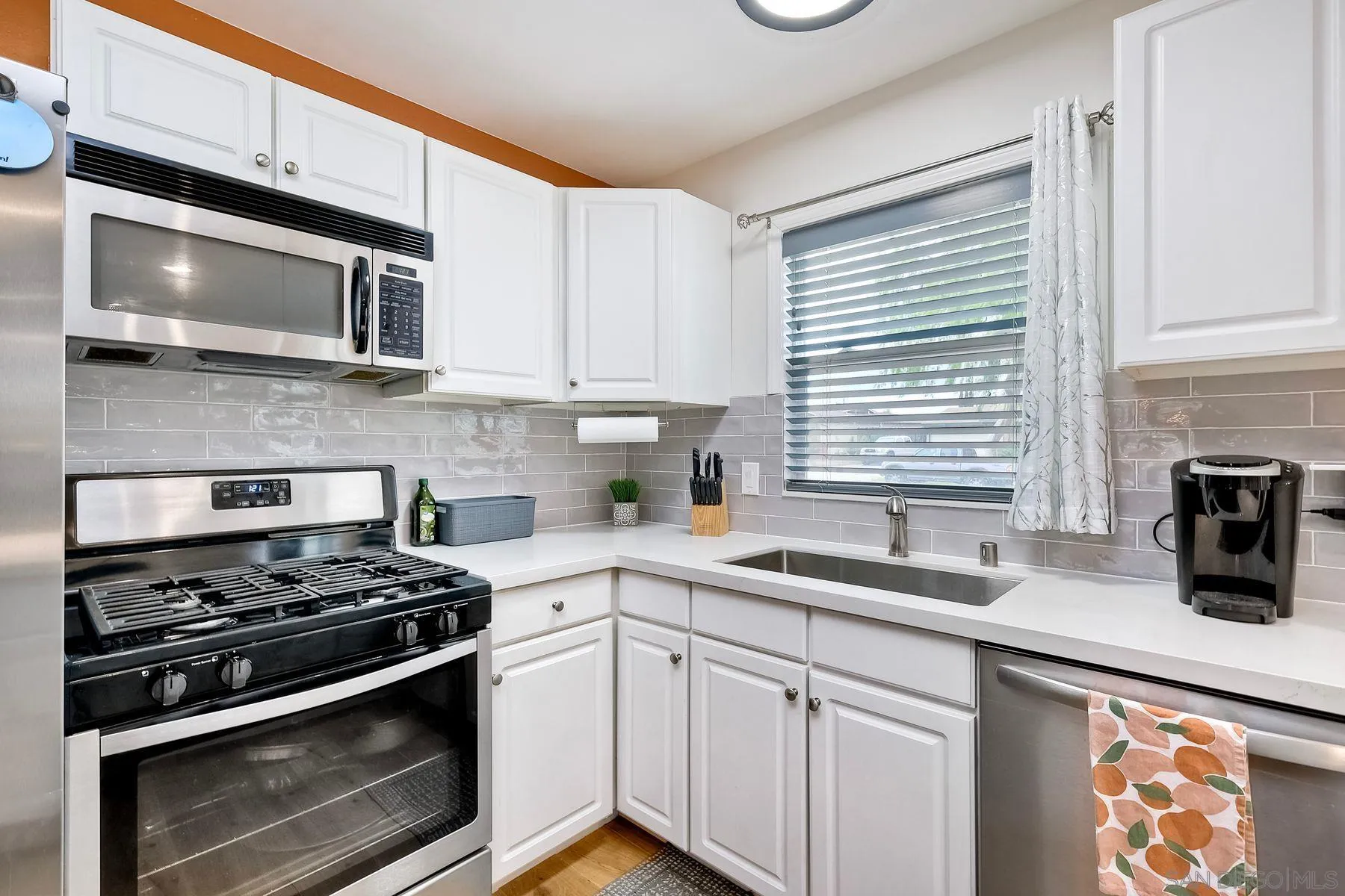 9410 Pike Road Santee, CA 92071 - Photo 12 of 25 a kitchen with stainless steel appliances white cabinets granite counter tops and a window