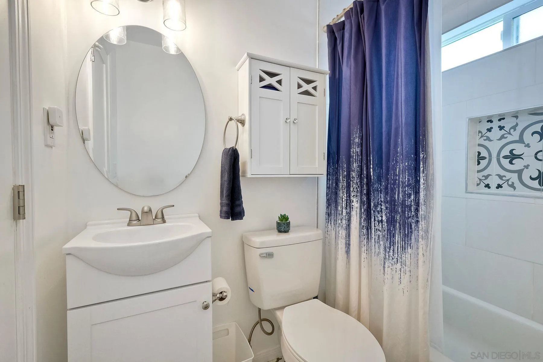 9410 Pike Road Santee, CA 92071 - Photo 21 of 25 a bathroom with a toilet sink and mirror