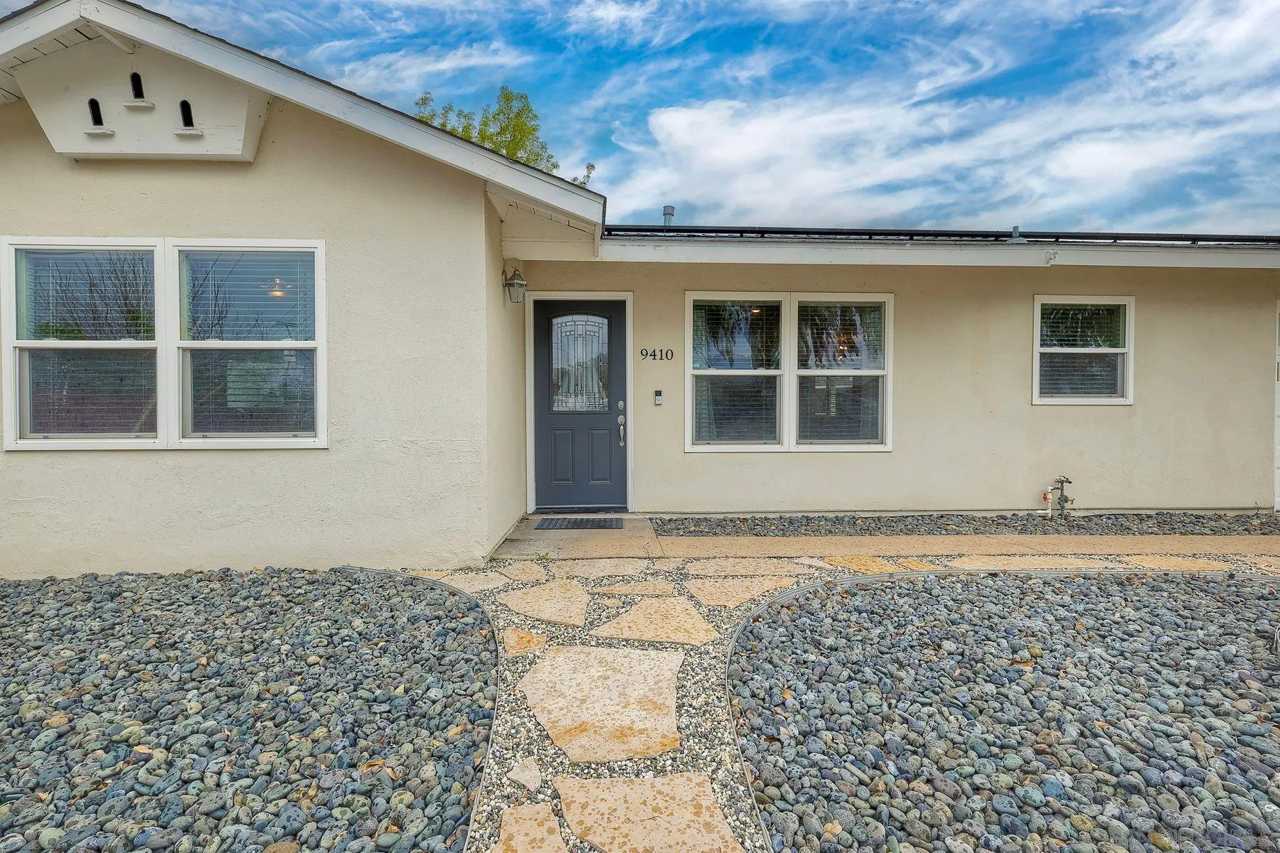 9410 Pike Road Santee, CA 92071 - Photo 4 of 25 a front view of a house with a yard