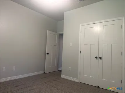 a bathroom with a toilet sink vanity and window