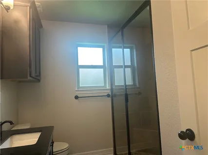 a kitchen with granite countertop a sink and cabinets