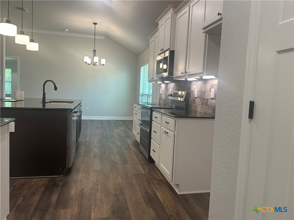2005 Edna Lane Troy, TX 76579 - Photo 2 of 30 a kitchen with stainless steel appliances granite countertop a sink a stove and a wooden floors