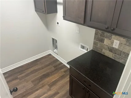 a view of empty room with a window and a ceiling fan