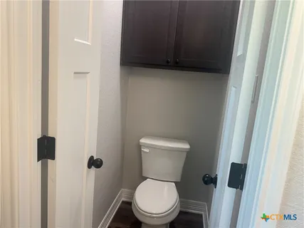 a white toilet sitting next to a sink