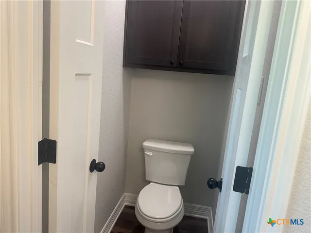 a white toilet sitting next to a sink