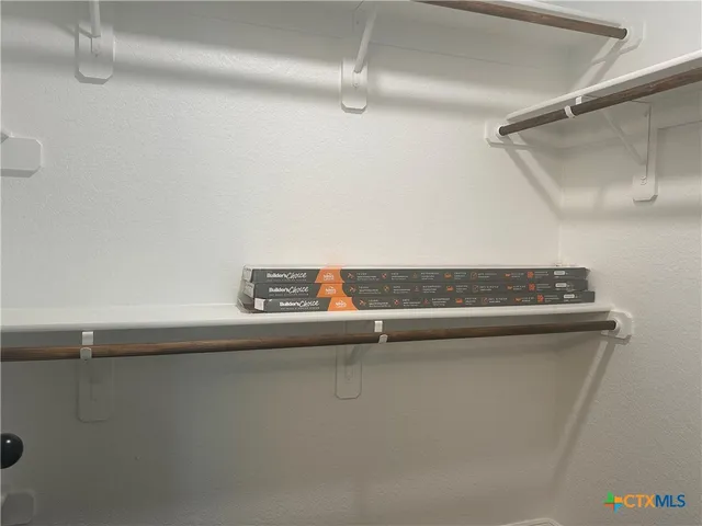 a bathroom with a granite countertop sink a mirror a glass door and shower