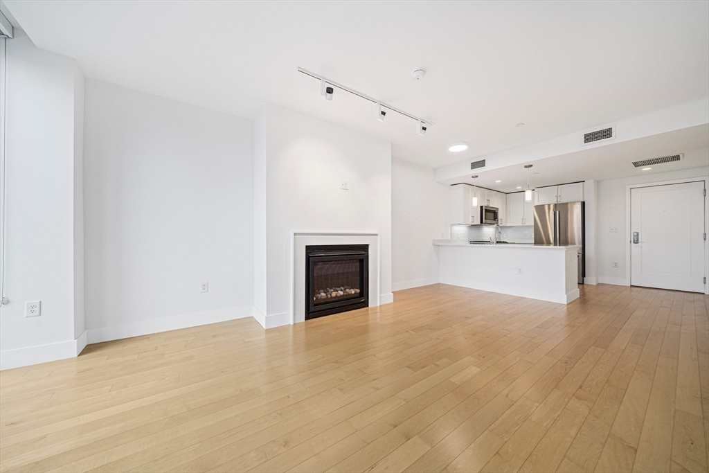 7 Beech Street, Unit 319 Cambridge, MA 02140 - Photo 2 of 27 a view of a big room with wooden floor and a kitchen