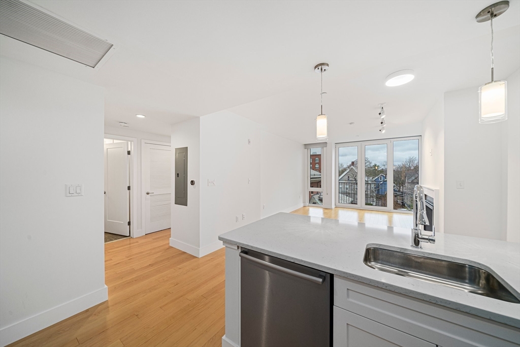 7 Beech Street, Unit 319 Cambridge, MA 02140 - Photo 5 of 27 a kitchen with stainless steel appliances granite countertop a sink a refrigerator and a granite counter tops