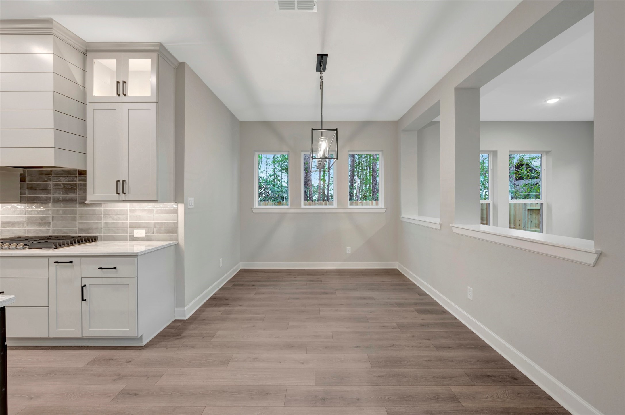 15722 Terracotta Terrace Conroe, TX 77302 - Photo 31 of 50 a view of an empty room with window and wooden floor