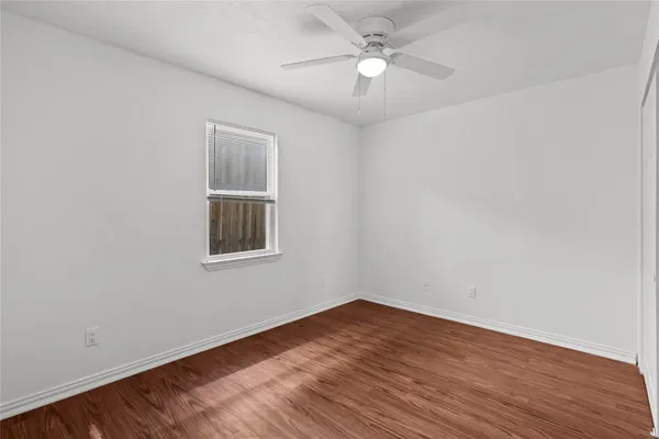 a bedroom with a bed and a potted plant