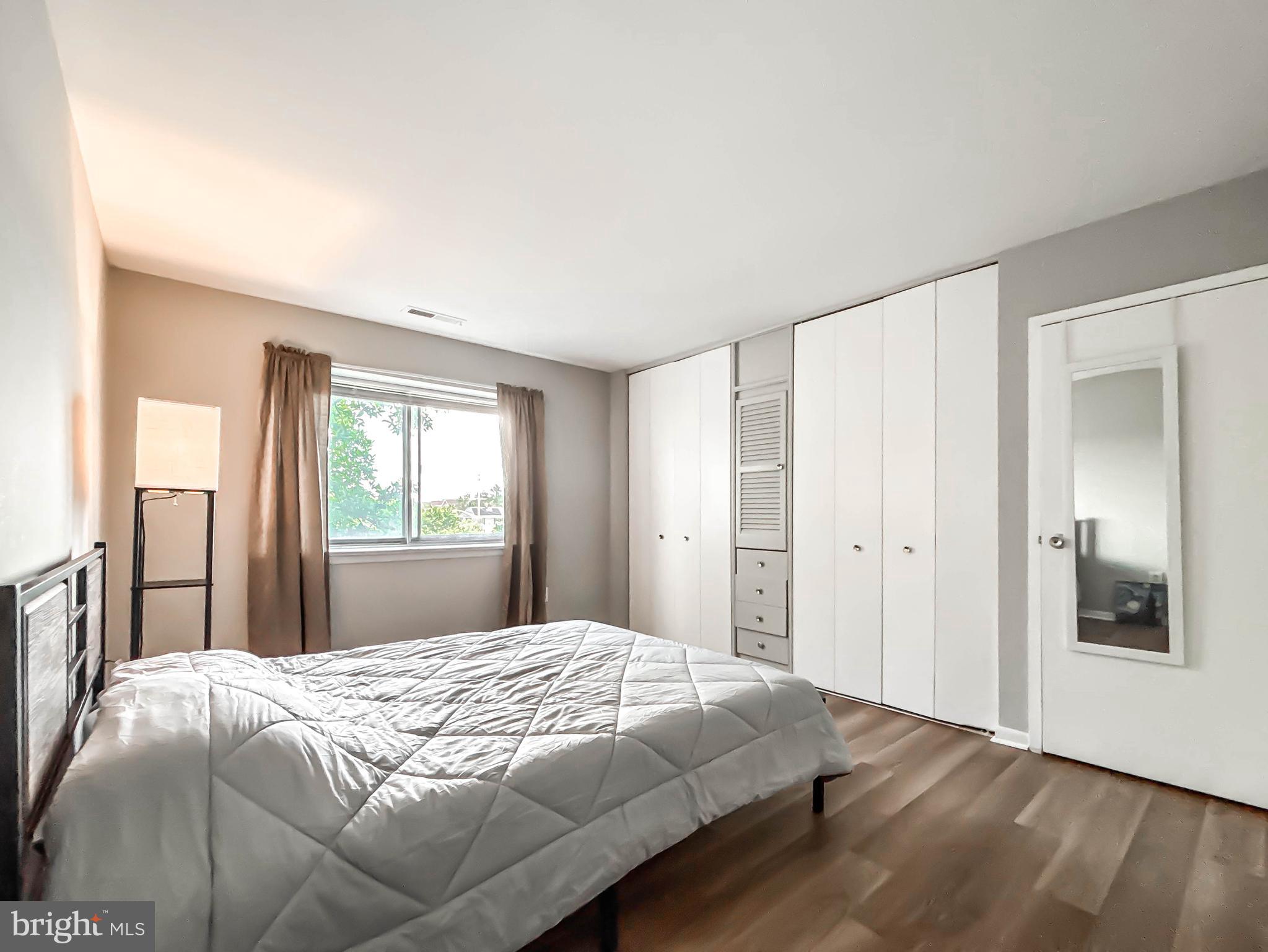 130 Slade Avenue, Unit 414 Baltimore, MD 21208 - Photo 24 of 48 a bedroom with a bed and a window