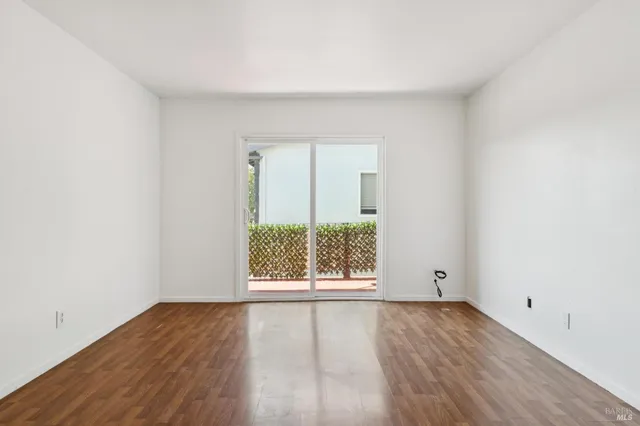 an empty room with a empty space and a ceiling fan