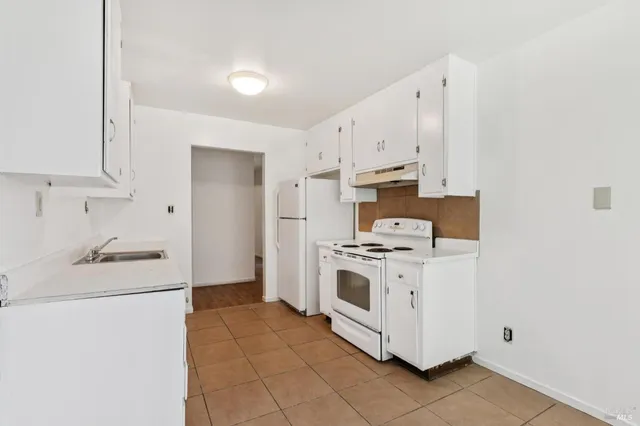 a kitchen with a sink cabinets and window