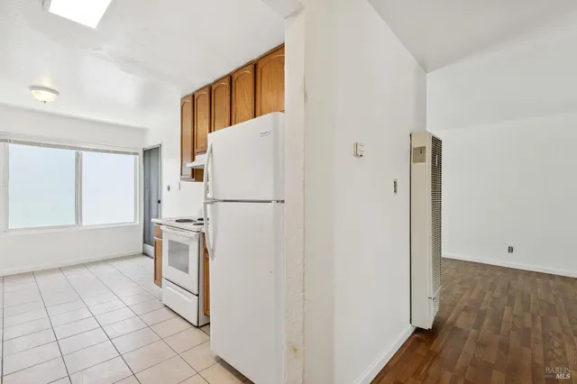 a kitchen with a sink and a stove next to a window