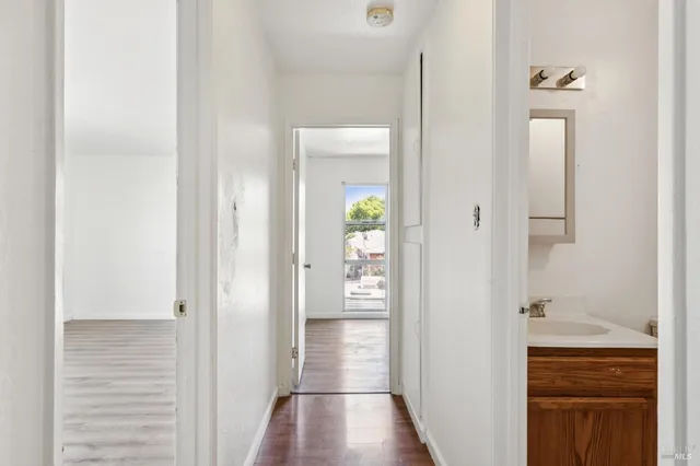 a view of an empty room with wooden floor