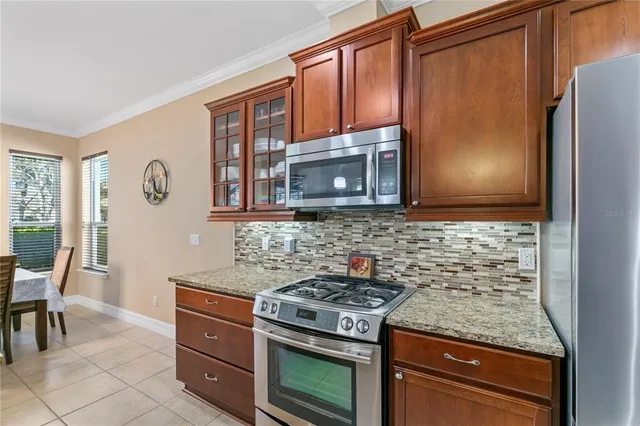 a kitchen with granite countertop cabinets and steel stainless steel appliances