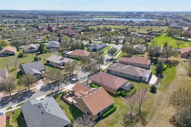 an aerial view of ocean residential house with swimming pool and green space