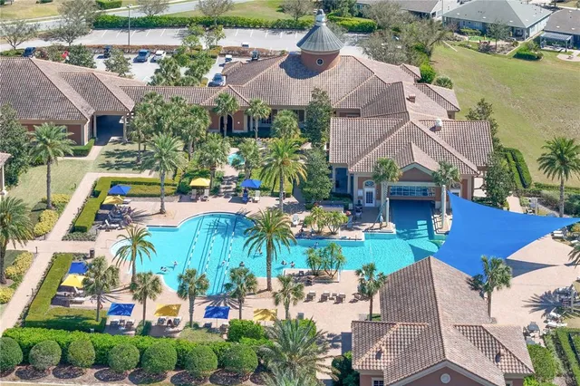 an aerial view of residential houses with outdoor space and swimming pool