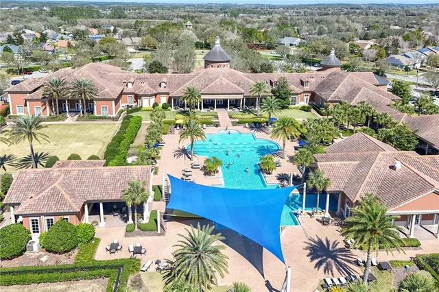 an aerial view of residential houses with outdoor space and swimming pool