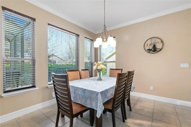 a dining room with furniture a chandelier and window