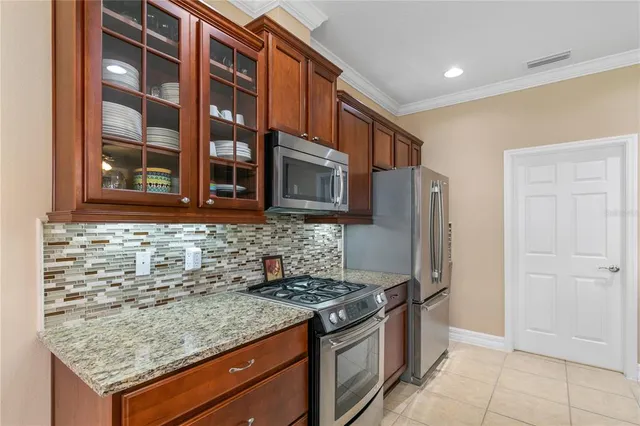 a kitchen with stainless steel appliances granite countertop a stove and a refrigerator